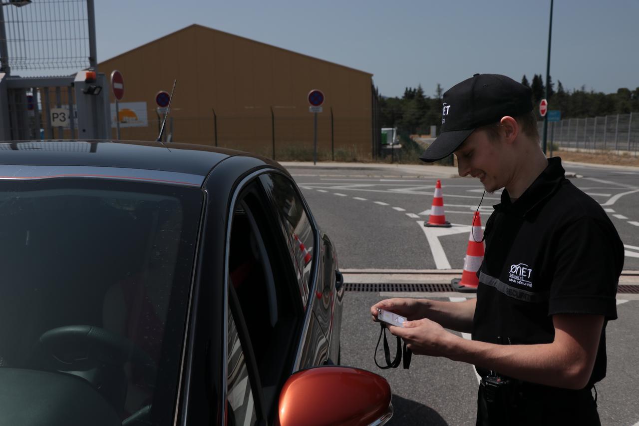 Security guard checking a visitor&#039;s badge.